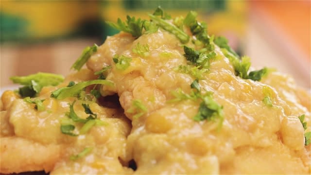 garnish fish fillets with coriander coat with corn saice