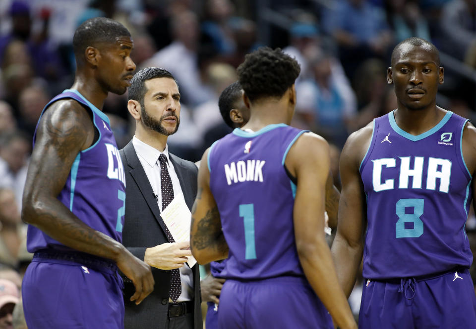 Charlotte Hornets coach James Borrego huddles with his team during a break in the first half of the team's NBA basketball game against the Boston Celtics in Charlotte, N.C., Thursday, Nov. 7, 2019. (AP Photo/Bob Leverone)