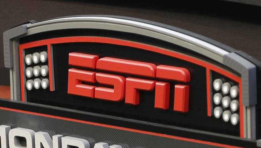 FILE - In this Sept. 16, 2013, file photo, an ESPN logo is seen prior to an NFL football game between the Cincinnati Bengals and the Pittsburgh Steelers in Cincinnati. The network will air the inaugural Overwatch League Grand Finals in prime time this month as part of a multiyear agreement to bring esports to the biggest sports platform on American television. Disney and Blizzard Entertainment announced plans Wednesday, July 11, 2018, to broadcast the OWL's playoffs and championship on ESPN, ABC and Disney XD. The Grand Finals on July 27 and 28 will be shown live on ESPN, marking the first time the network will carry esports in prime time. (AP Photo/David Kohl, File)