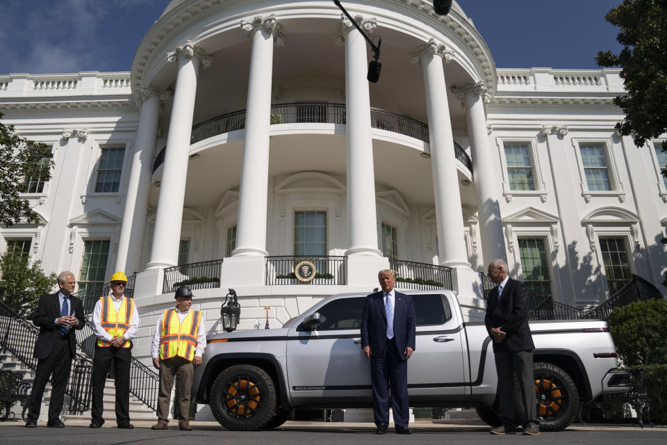 Lordstown Motors CEO Steve Burns shows President Donald Trump the Endurance all-electric pickup truck, made in Lordstown, Ohio, at the White House, Monday, Sept. 28, 2020, in Washington. (AP Photo/Evan Vucci)