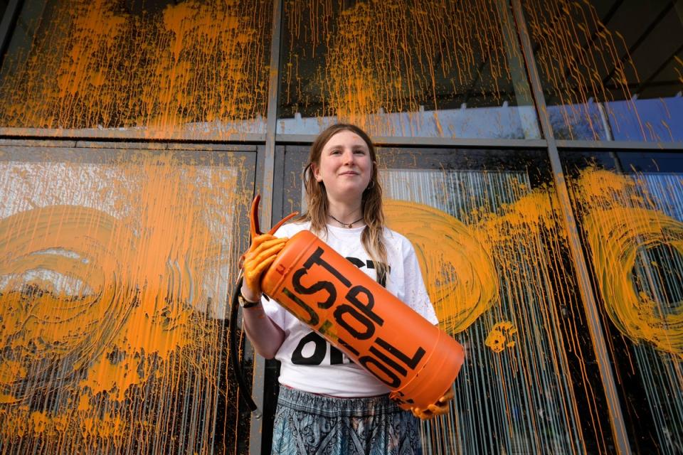 Just Stop Oil protestor Lucy Hammil talks to the media after spraying orange paint over the Allen Gilbert Buiding at Manchester University on October 12, 2023 (Christopher Furlong / Getty Images)