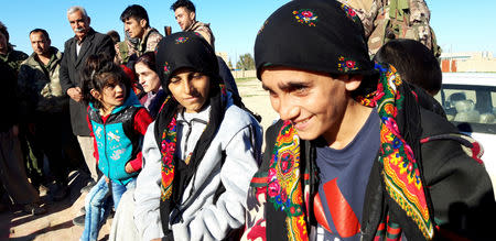 Yazidi children survivors are greeted by residents of Sinuni following their release from Islamic State militants in Syria, in Sinuni, Iraq March 1, 2019. REUTERS/Fahed Khodor