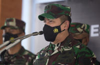 Indonesian military spokesperson Maj. Gen. Achmad Riad, center, talks to reporters during a press conference at the Ngurah Rai airport in Bali, Indonesia on Thursday, April 22, 2021. Indonesia's navy ships are intensely searching the waters where one of its submarines was last detected before it disappeared, as neighboring countries are set to join the complex operation. (AP Photo/Firdia Lisnawati)