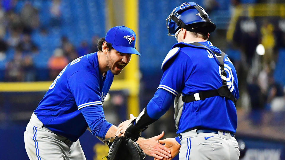 Jordan Romano #68 celebrates with Danny Jansen #9 of the Toronto Blue Jays after defeating the Tampa Bay Rays. (Photo by Julio Aguilar/Getty Images)