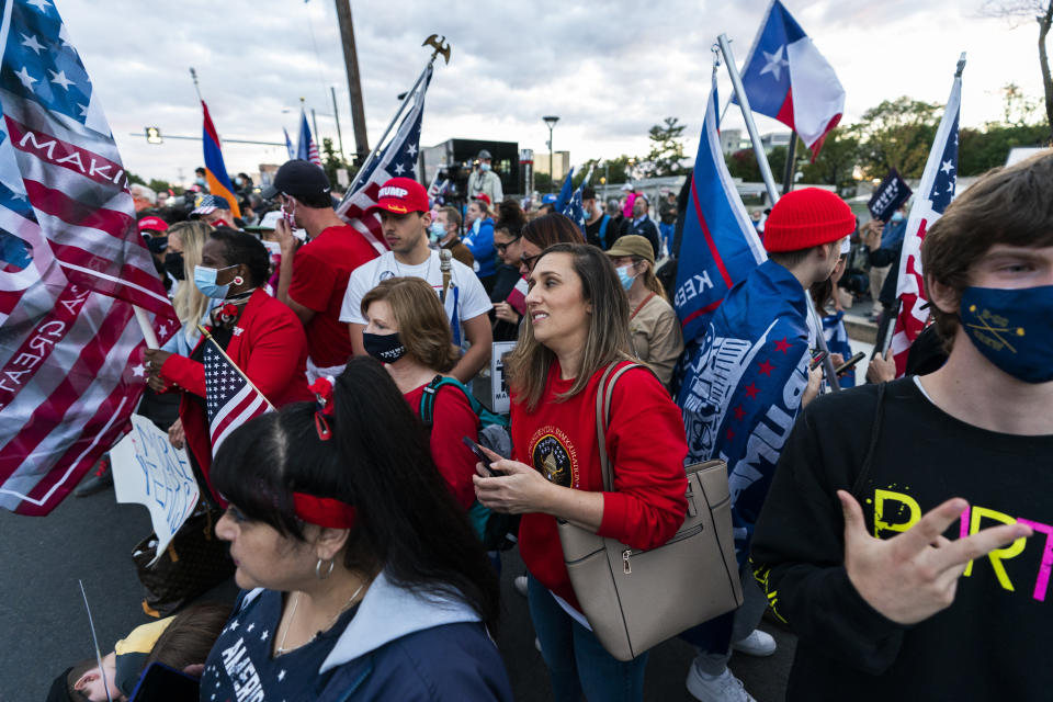 Supporters of President Donald Trump wait outside Walter Reed National Military Medical Center in Bethesda, Md., Monday, Oct. 5, 2020. Stepping gingerly, President Donald Trump walked out the military hospital Monday night where he has been receiving an unprecedented level of care for COVID-19, immediately igniting a new controversy by declaring that despite his illness the nation should fear the virus that has killed more than 210,000 Americans. (AP Photo/Manuel Balce Ceneta)