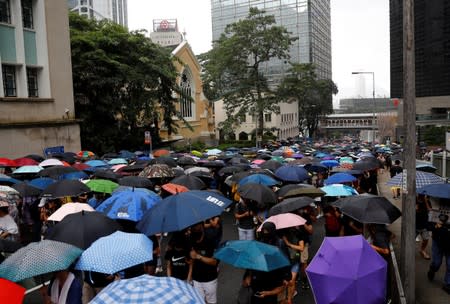 People carry umbrellas as they attend a protest in Hong Kong