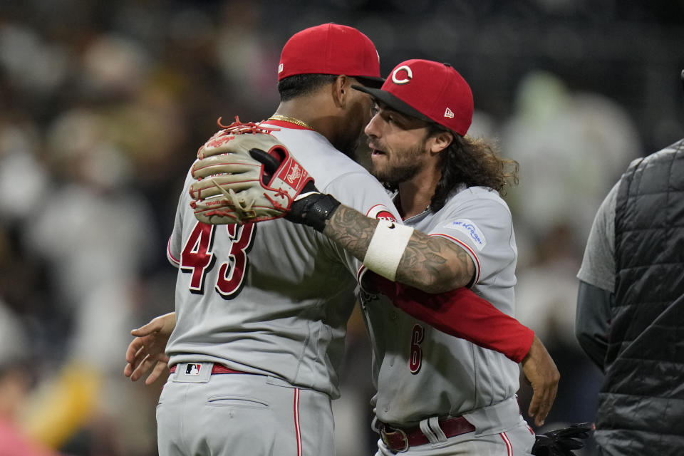 Cincinnati Reds relief pitcher Alexis Diaz, left, hugs second baseman Jonathan India after the Reds defeated the San Diego Padres 2-1 in a baseball game Tuesday, May 2, 2023, in San Diego. (AP Photo/Gregory Bull)