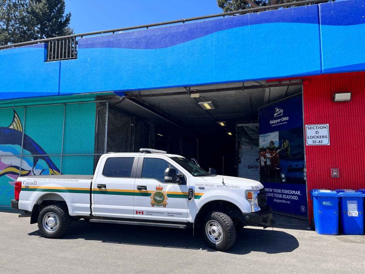 A pickup truck belonging to the Department of Fisheries and Oceans is parked outside the Fisherman's Wharf facility belonging to Skipper Otto community-supported Fishery. Officers seized 680 kilograms of fish. (Mike Joyce/Skipper Otto - image credit)