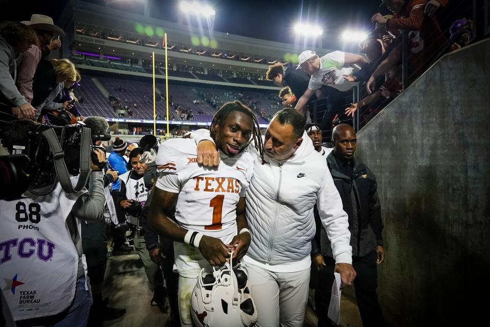 Texas Longhorns head coach Steve Sarkisian hugs Texas Longhorns wide receiver Xavier Worthy as they walk back into the locker room after beating TCU Horned Frogs 29-26 in an NCAA college football game, Saturday, November. 11, 2023, at Amon G. Carter Stadium in Fort Worth, Texas.