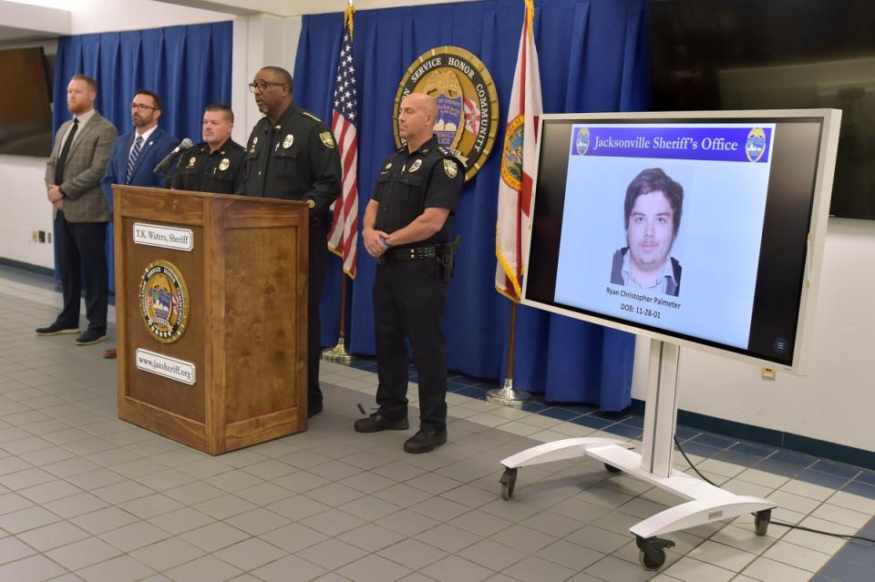 A photograph of shooter Ryan Christopher Palmeter is shown on a video monitor during Sheriff TK Waters’ press conference at the Jacksonville Sheriff's Office headquarters in Florida on Sunday (Bob Self/The Florida Times-Union/AP)