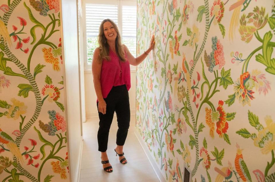 Emily Valdez with EXP Realty describes the wallpaper of the historic Wilder House in Sacramento’s Alkali Flat neighborhood on Monday. “We’re in the city of trees, so you’re just surrounded by lush trees and wildlife,” Valdez said of the house’s exterior surroundings.