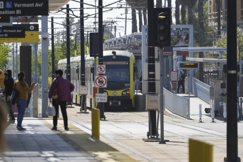 A Metro light rail train resumes service in Los Angeles, Tuesday, April 30, 2024. Officials say multiple people were hurt, and a few seriously, when a Metro light rail train and a University of Southern California shuttle bus collided in downtown Los Angeles. (AP Photo/Damian Dovarganes)