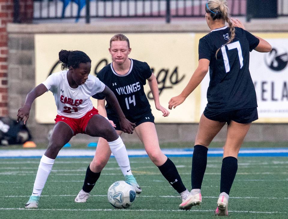 Lakeland Christian's Grace Ham pressures high-scoring Jahpetria Charles of Jupiter Christian as Caroline Morin closes in to help on Friday night in the Class 2A, Region 7 semifinals at Viking Stadium.
