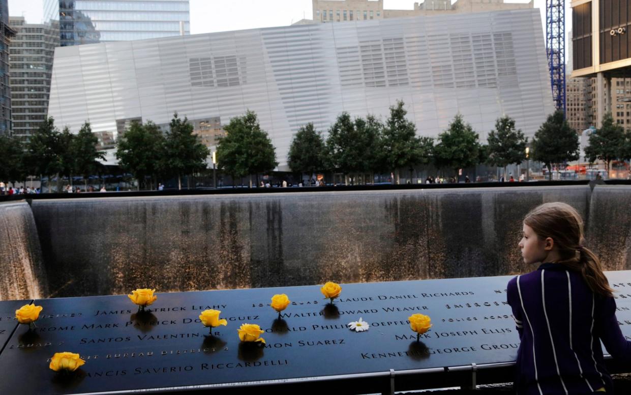  Charlotte Newman, 8, visits the National September 11 Memorial and Museum in New York - AP