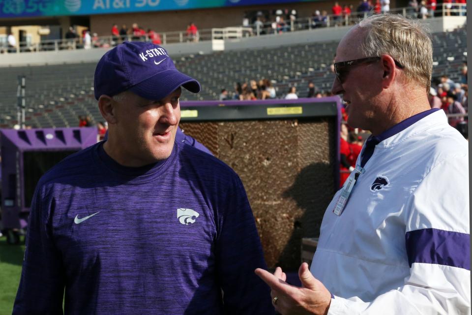 Kansas State athletics director Gene Taylor, right, visits with head football coach Chris Klieman before a 2021 game against Texas Tech in Lubbock, Texas.