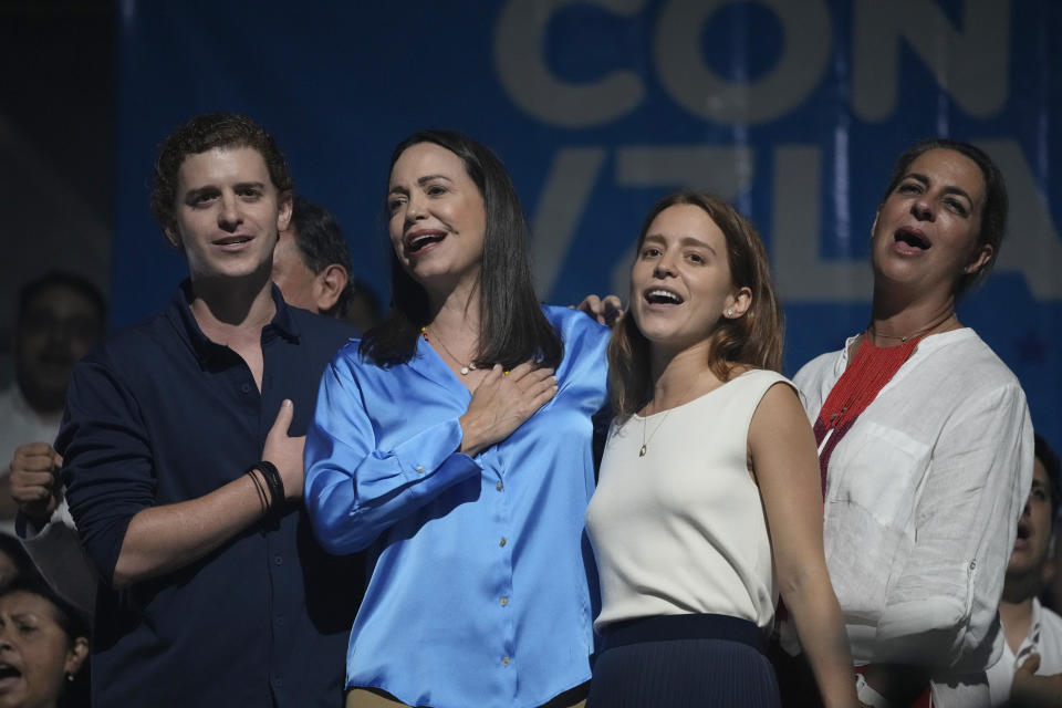 Opposition presidential hopeful Maria Corina Machado, center, sings the Venezuelan national anthem with her family, after winning the opposition primary election, at her campaign headquarters in Caracas, Venezuela, Monday, Oct. 23, 2023. Machado will run against President Nicolás Maduro in the 2024 presidential elections. (AP Photo/Ariana Cubillos)