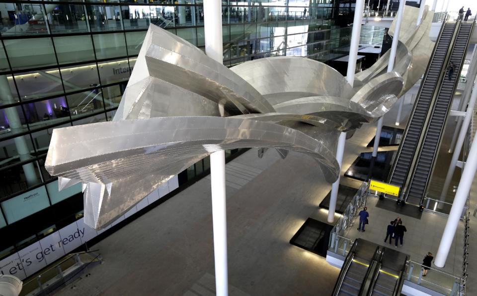 The sculpture 'Slipstream' at the new Heathrow Airport Terminal 2 in London, Wednesday, April 23, 2014. Slipstream by artist Richard Wilson will be the longest permanent sculpture in Britain, measuring 78 metres and weighing 77 tonnes. The 2.5 billion pound ($4.2 billion) new Terminal 2 is due to open to the public in June after 5-years in development, to handle the anticipated 20 million passengers per year. (AP Photo/Kirsty Wigglesworth)