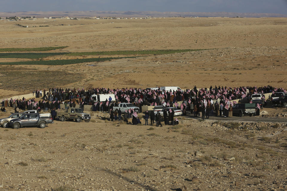 Mourners joined a funeral procession Saturday, Nov. 10, 2018, for a mother and her two daughters who were killed a day earlier in flash floods in the Dabaa area, south of the capital of Amman. (AP Photo/Raad Adayleh)