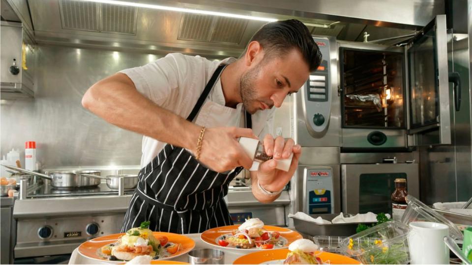 Chef Anthony grinding pepper over a dinner dish in Below Deck