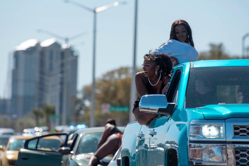 Spring breakers dance on top of cars as they sit in traffic along Highway 90 during Black Spring Break in Biloxi on Saturday, April 9, 2022.