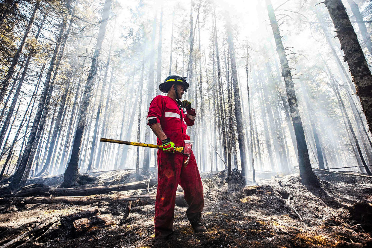 Image: Halifax Regional Fire and Emergency firefighter Zach Rafuse from Port Williams works to put out fires in the Tantallon area of Nova Scotia on May 30, 2023. (Nova Scotia Government via AFP - Getty Images)