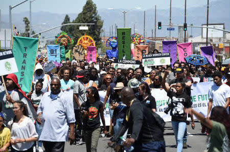 Protesters march from the intersection of Florence and Normandie Avenue, the flashpoint where the riots started 25 years ago, to a nearby park for a rally to remember and honor the victims of the 1992 Los Angeles riots in Los Angeles, California, U.S., April 29, 2017. REUTERS/Kevork Djansezian