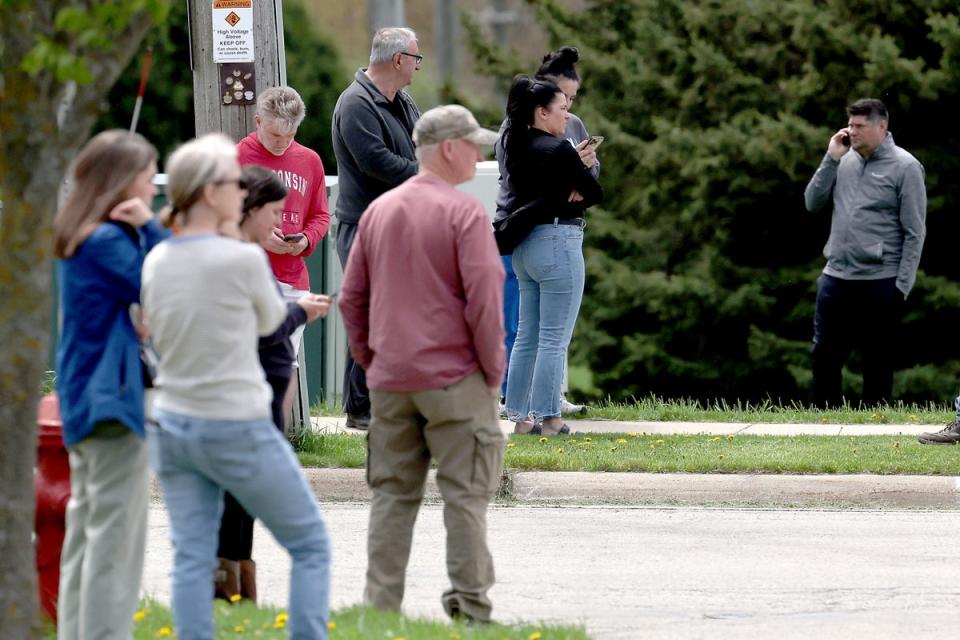 Family members wait as law enforcement personnel respond to the report of an active shooter at Mount Horeb Middle School in Mount Horeb, Wisconsin on Wednesday (Wisconsin State Journal)