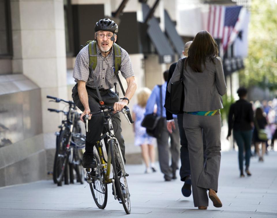 Retired physician David Hilfiker, of Washington, leaves the National Press Club on his bike after talking about his life with Aalzheimer's in Washington, Thursday, Sept. 19, 2013. Hilfiker, was diagnosed in September 2012, and has been writing about the experience of losing his mental capacity in his blog "Watching the Lights Go Out." Nearly half of all seniors who need some form of long-term care, from help at home to full-time care in a facility, have dementia, the World Alzheimer Report said Thursday. (AP Photo/Cliff Owen)