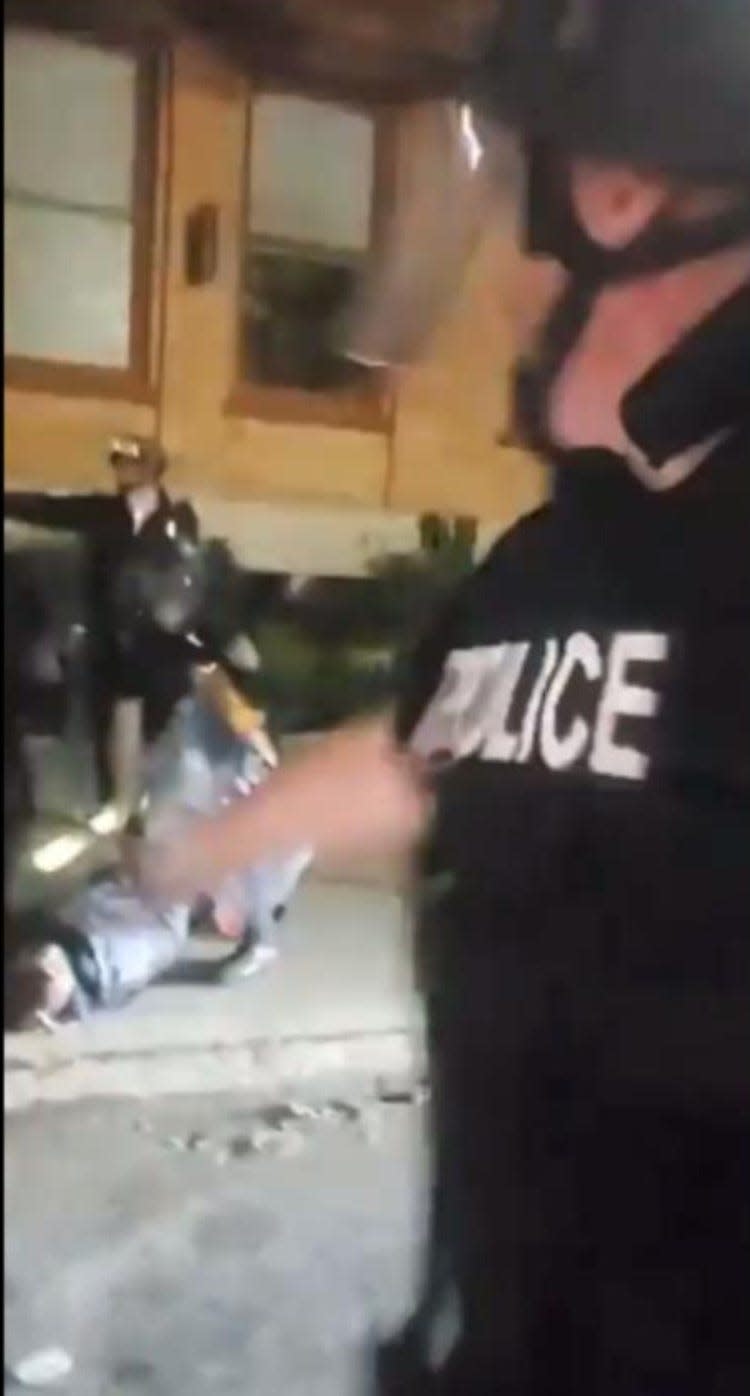 Darryl Jordan, prone on the sidewalk at bottom left, is arrested by police during the protest outside Providence Place mall on June 2, 2020. The cellphone image was part of the court filing accompanying a lawsuit filed against the City of Providence.