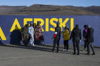 Departing visitors take a souvenir photograph with local herdsmen at the Afriski ski resort near Butha-Buthe, Lesotho, Sunday July 31, 2022. While millions across Europe sweat through a summer of record-breaking heat, Afriski in the Maluti Mountains is Africa's only operating ski resort south of the equator. It draws people from neighboring South Africa and further afield by offering a unique experience to go skiing in southern Africa. (AP Photo/Jerome Delay)