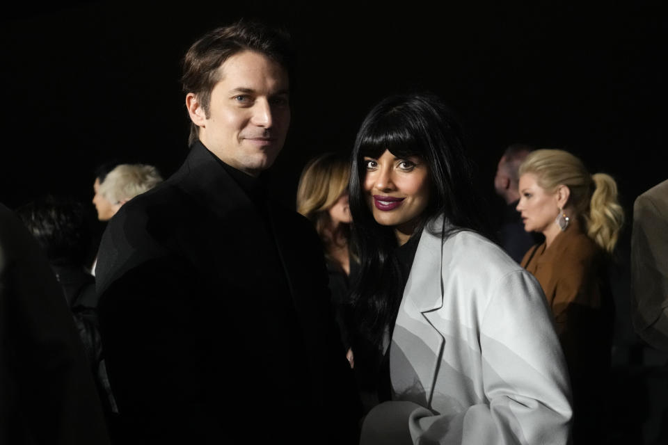 French actor Lucas Bravo, left, attends the men's Zegna Fall-Winter 2024-2025 collection, that was presented in Milan, Italy, Monday, Jan. 15, 2024. (AP Photo/Luca Bruno).