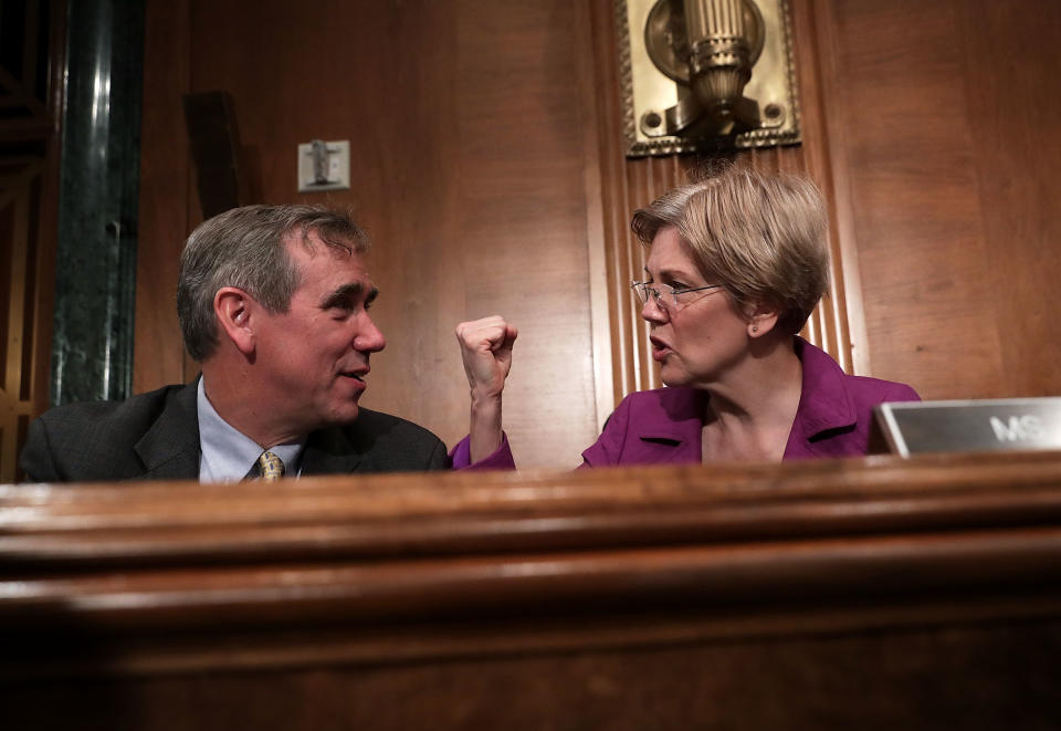 WASHINGTON, DC - APRIL 07:  U.S. Sen. Jeff Merkley (D-OR) (L) talks to Sen. Elizabeth Warren (D-MA) (R) prior to a hearing before the Senate Banking, Housing and Urban Affairs Committee April 7, 2016 on Capitol Hill in Washington, DC. The committee held a hearing on 