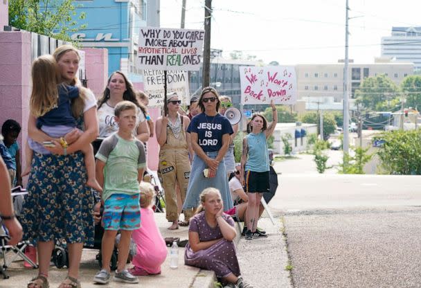 Abortion rights supporters wave their signs and shout to be heard above the singing from anti-abortion supporters, in the foreground, as they all stand outside the Jackson Women's Health Organization clinic in Jackson, Miss., July 7, 2022. (Rogelio V. Solis/AP)