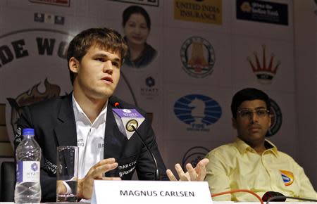 Norway's Magnus Carlsen speaks during a news conference as India's Viswanathan Anand (R) looks on after Carlsen clinched the FIDE World Chess Championship in the southern Indian city of Chennai November 22, 2013. REUTERS/Babu