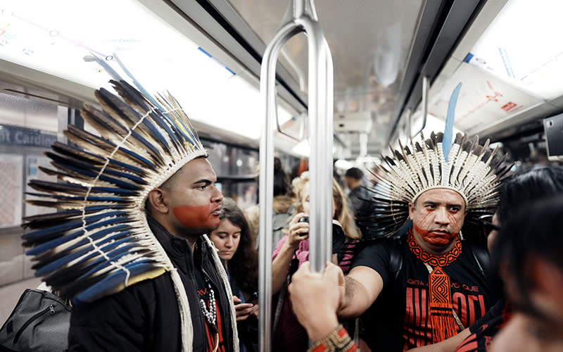 Indigenous representatives from Brazil are seen on the metro after a deforestation protest outside a Paris courthouse