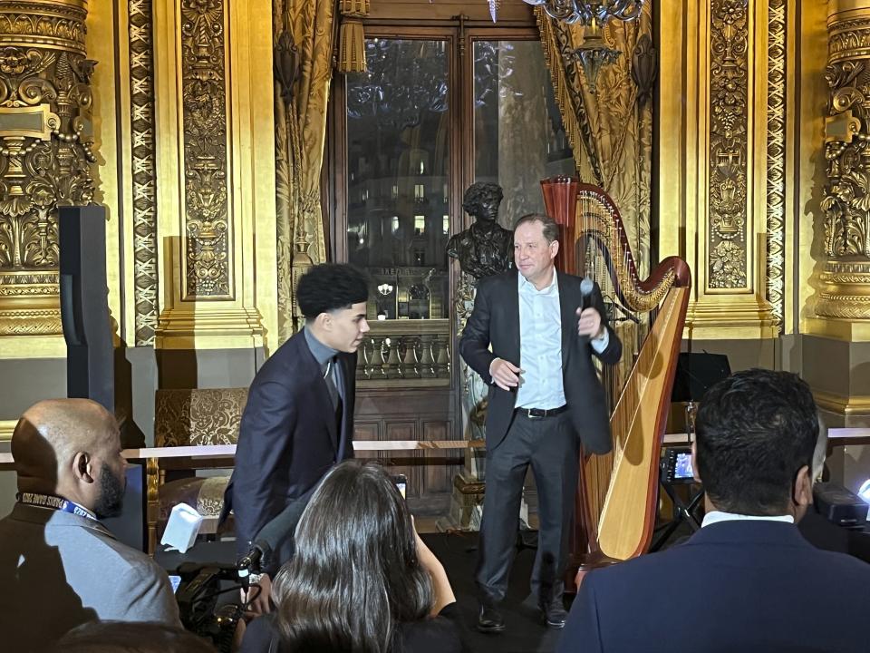 Detroit Pistons vice chairman Arn Tellem welcomes the NBA basketball team and their families to a private party at the Paris Opera House Tuesday night, Jan. 17, 2023, in Paris, France. At top left is Pistons' Killian Hayes. The Detroit Pistons play the Chicago Bulls in Paris on Thursday. (AP Photo/Tim Reynolds)