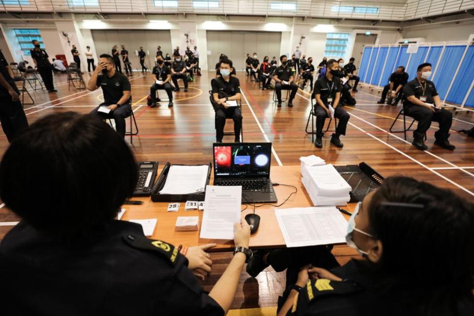 Home Team officers awaiting their vaccinations on Monday (11 January). (PHOTO: MHA)