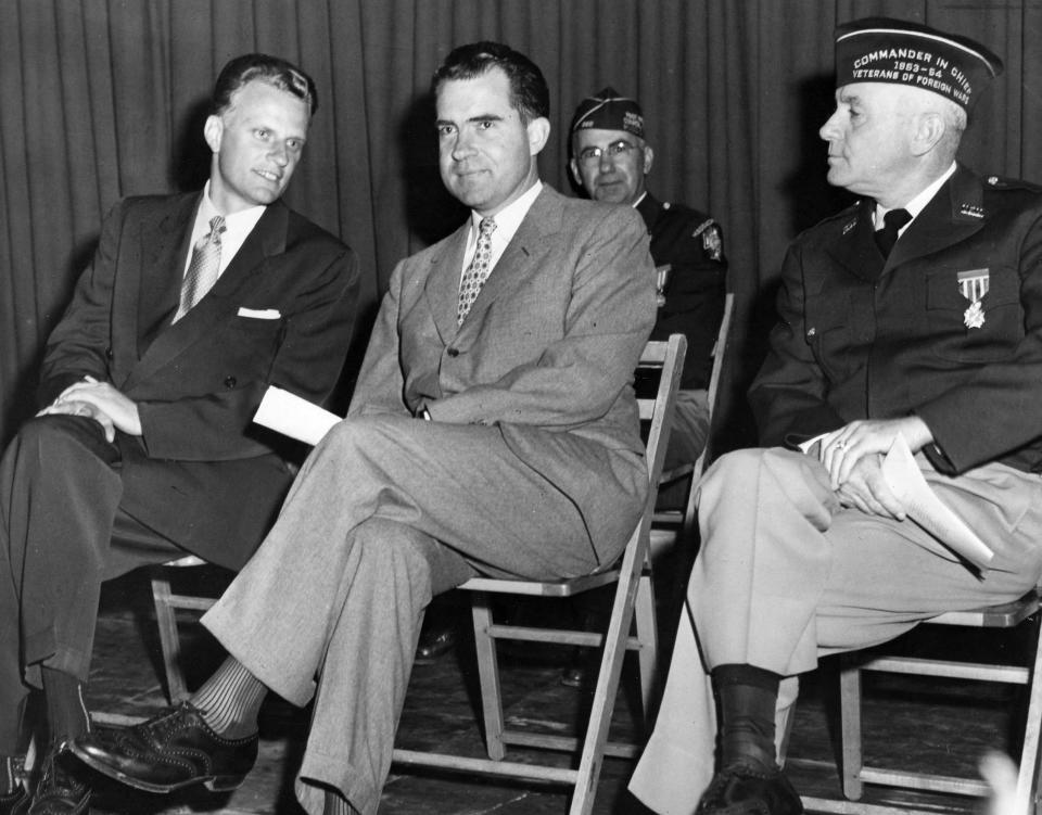 Then-Vice President Richard Nixon sits with Graham, left, and National Commander Merton B. Rice, at a memorial service during the Veterans of Foreign Wars Convention at Boston University on Aug. 28, 1955.