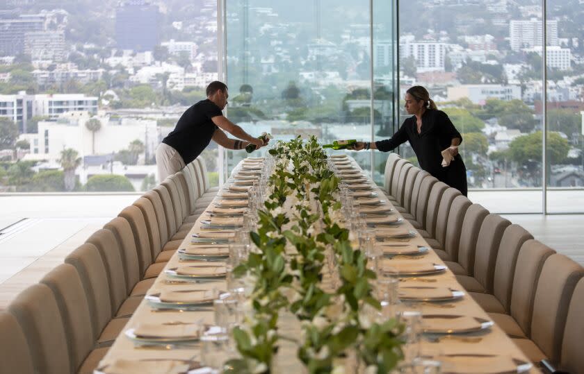 West Hollywood, CA - June 15: Wine is poured as staff prepares a five-course dinner during a VIP event at 8899 Beverly, one of the most exclusive condo residences ever built on Wednesday, June 15, 2022 in West Hollywood, CA. (Brian van der Brug / Los Angeles Times)