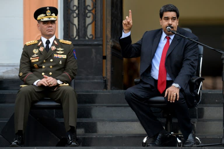 Venezuelan President Nicolas Maduro (R), next to Defence Minister Padrino Lopez. has given his military sweeping powers over food production and distribution