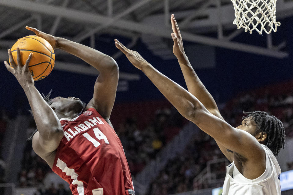Alabama center Charles Bediako (14) works for a shot with South Alabama center Kevin Samuel (21) defending during the first half of an NCAA college basketball game Tuesday, Nov. 15, 2022, in Mobile, Ala. (AP Photo/Vasha Hunt)