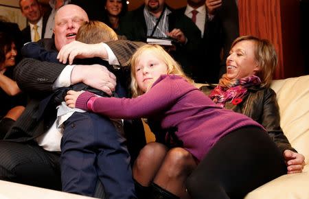 Mayor Rob Ford (L) is congratulated by his children Doug and Stephanie as his wife Renata (R) looks on while watching the municipal election results in Toronto, October 27, 2014. Ford was elected as a city councillor. REUTERS/Mark Blinch