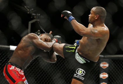 Daniel Cormier kicks Anthony Johnson during their light heavyweight title fight at UFC 187. (AP)