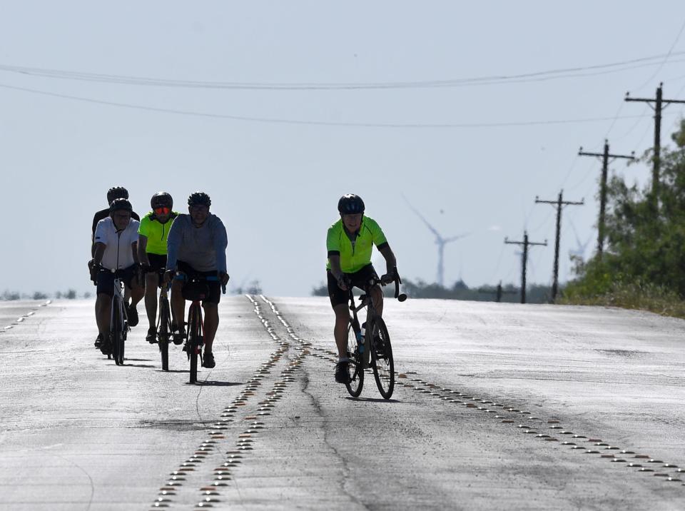 Bo Green separates momentarily on E.N. Tenth Street from the group accompanying him on his 80-mile ride as they approach Taylor Elementary School Saturday.