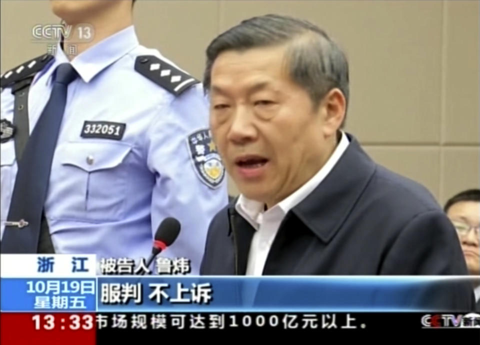 In this image taken from video, Lu Wei, former minister of China's Cyberspace Administration, speaks during his trial in the city of Ningbo in eastern China's Zhejiang province, Friday, Oct. 19, 2018. China's former internet censor, who once held high-profile meetings with industry leaders such as Apple chief executive Tim Cook and Facebook founder Mark Zuckerberg, stood trial on Friday on corruption allegations. Chinese headlines at the bottom reads: "Obey sentencing, Will not appeal." (CCTV via AP)