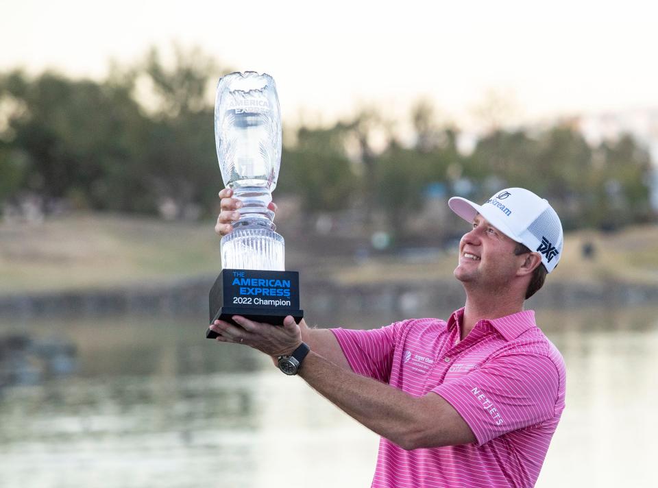 Hudson Swafford holds up his trophy after winning The American Express at PGA West in La Quinta, Calif., Sunday, Jan. 23, 2022. 