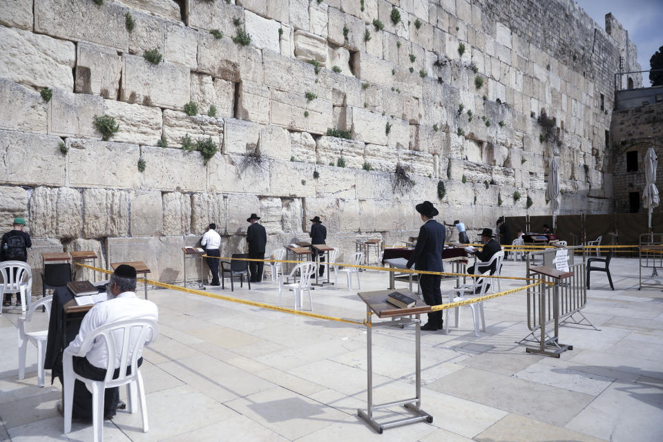 Ultra Orthodox Jews pray at the Western Wall in Jerusalem, Sunday, March 15, 2020. Israel imposed sweeping travel and quarantine measures more than a week ago but has seen its number of confirmed coronavirus cases double in recent days, to around 200. On Saturday, the government said restaurants, malls, cinemas, gyms and daycare centers would close. (AP Photo/Mahmoud Illean)
