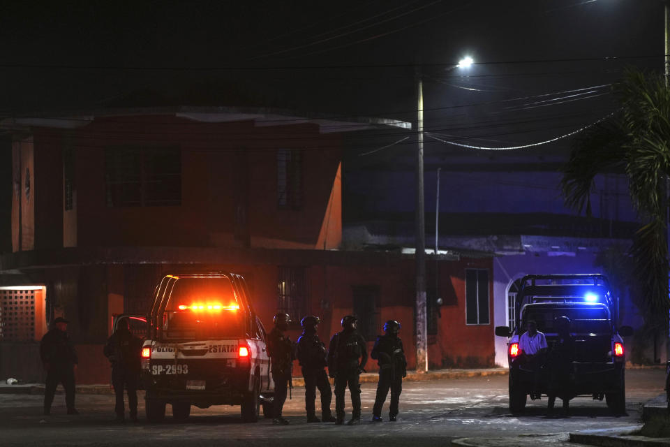 Special forces police officers stand guard after residents protested the death of Brando Arellano Cruz, fatally shot by police after he failed to pull over, in Lerdo de Tejada near Veracruz, México, Saturday, Jan. 19, 2024. Four municipal police officers are under investigation in relation to the death of the young man, after the victim's neighbors staged violent protests and attempted to lynch the officers. (AP Photo/Felix Marquez)