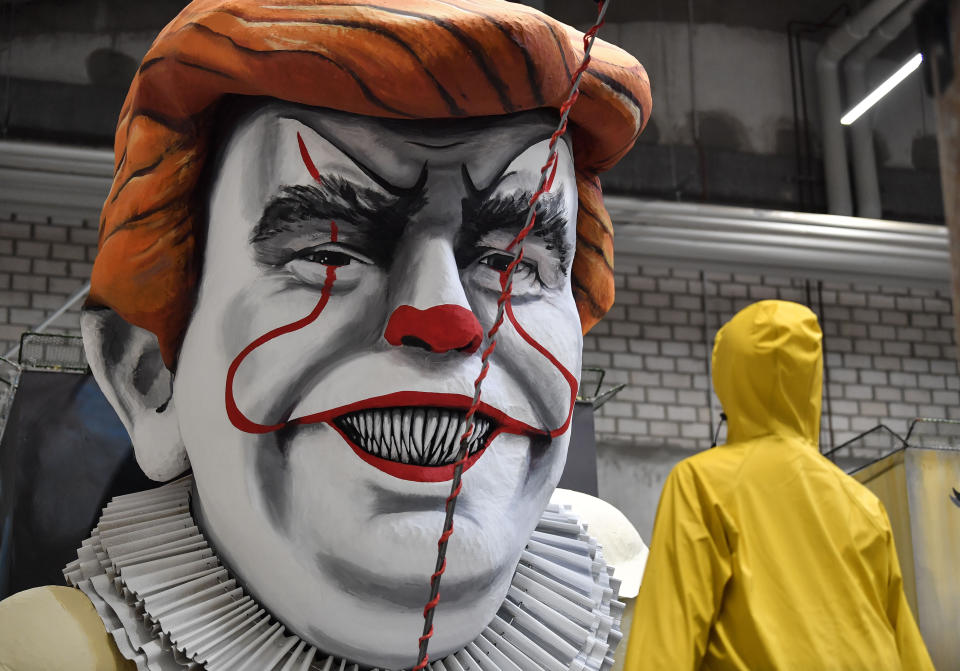 A satiric carnival float depicting US President Donald Trump as horror clown Pennywise is pictured during a preview in a hall in Cologne, Germany, Tuesday, Feb. 18, 2020. The traditional carnival parades on Rosemonday make fun of politics and are watched by hundreds of thousands in the streets of Cologne, Duesseldorf and Mainz. (AP Photo/Martin Meissner)