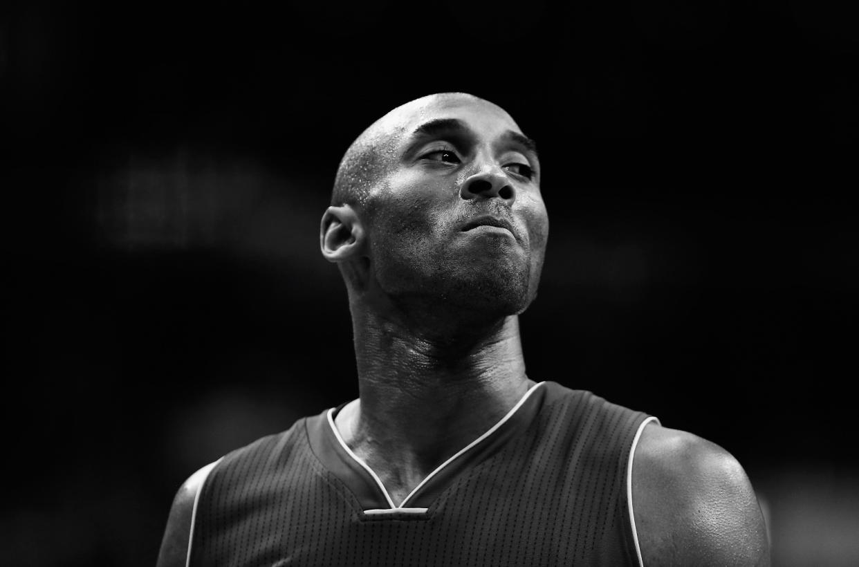 Image has been converted to black and white) Kobe Bryant #24 of the Los Angeles Lakers looks on against the Washington Wizards in the first half at Verizon Center on December 2, 2015 in Washington, DC.